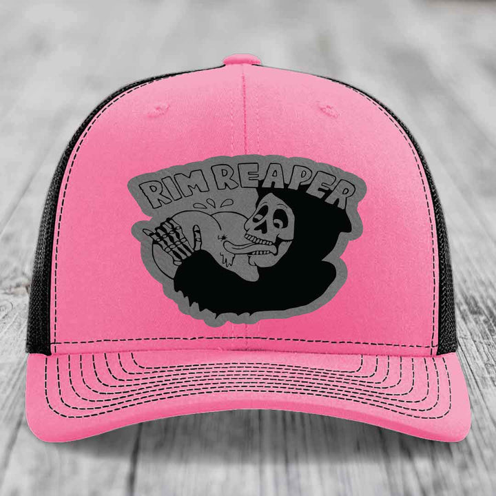 Pink trucker hat with black mesh back and gray skull graphic that says Rim Reaper