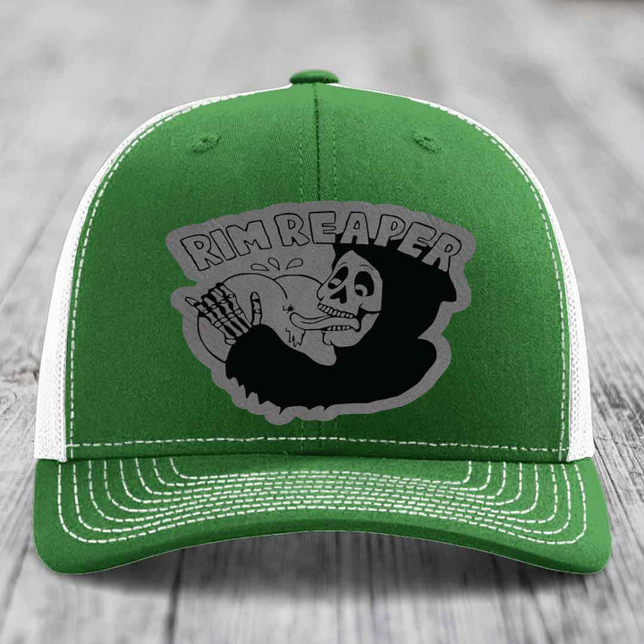 Green trucker hat with white mesh back and embroidered &