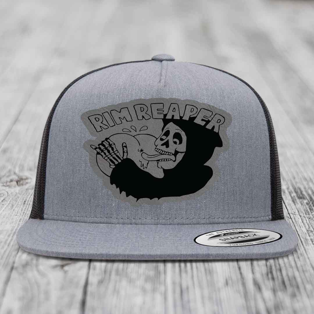 Grey trucker hat with black mesh back and a black &