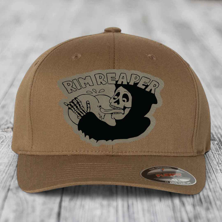Tan baseball cap with black skull and &