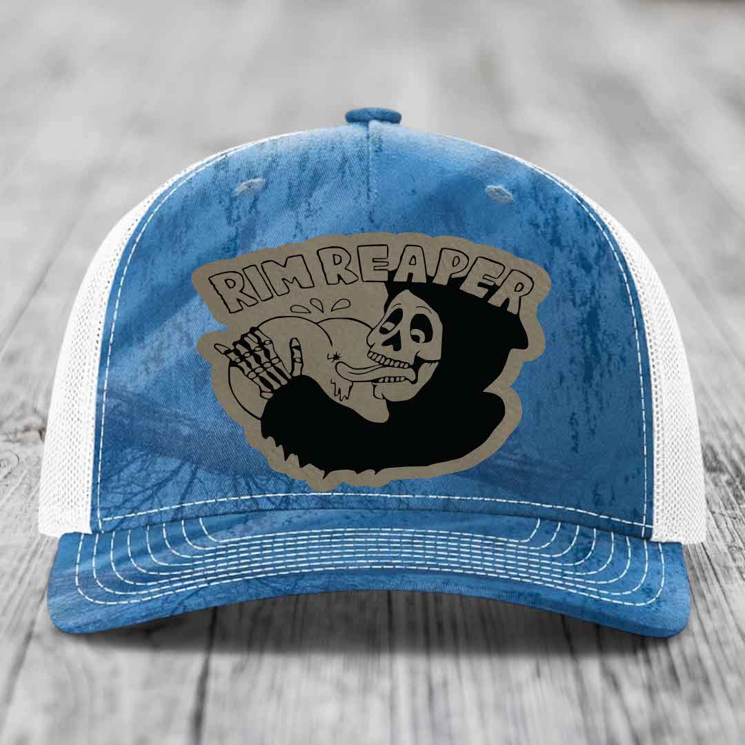 Blue and white trucker hat with a skull graphic and &