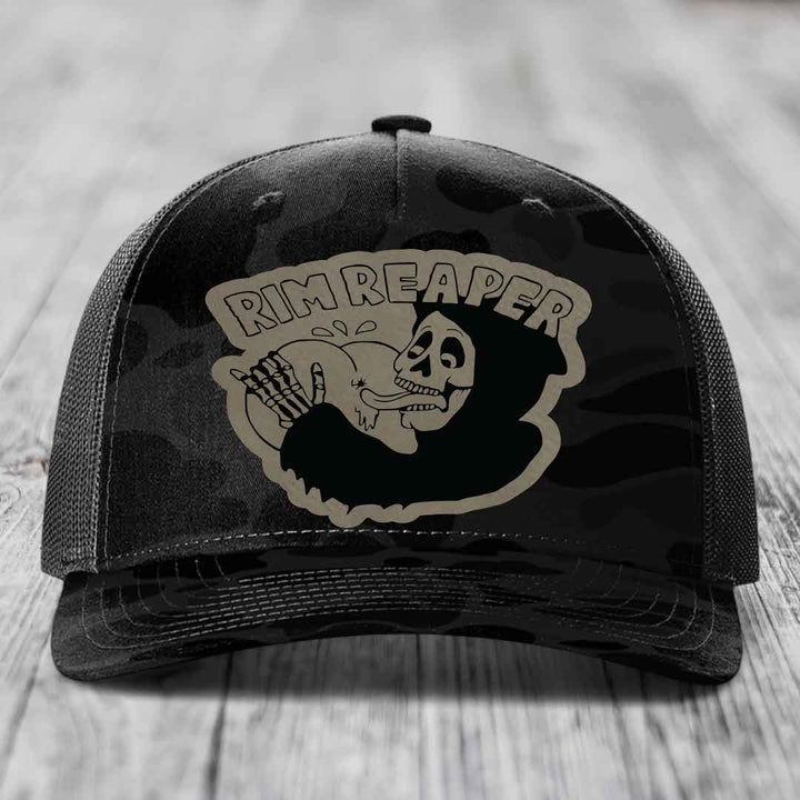 Black trucker hat with grey camo pattern and &
