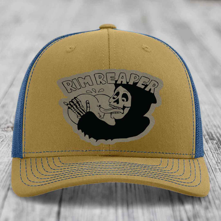 Tan and blue trucker hat with &