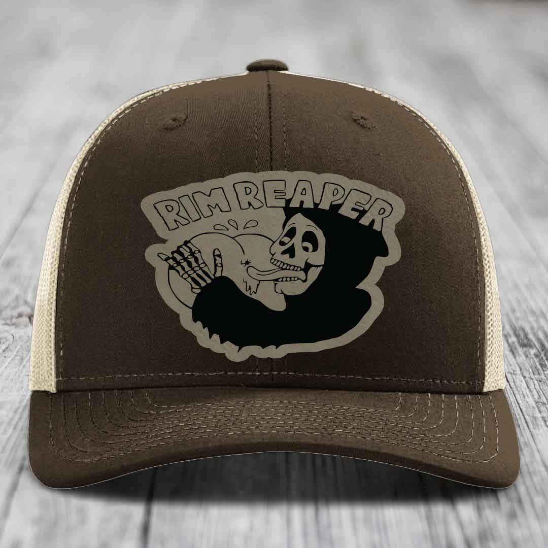 Brown trucker hat with beige mesh back and embroidered &