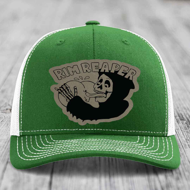 Green trucker hat with white mesh back and stitching, featuring a &