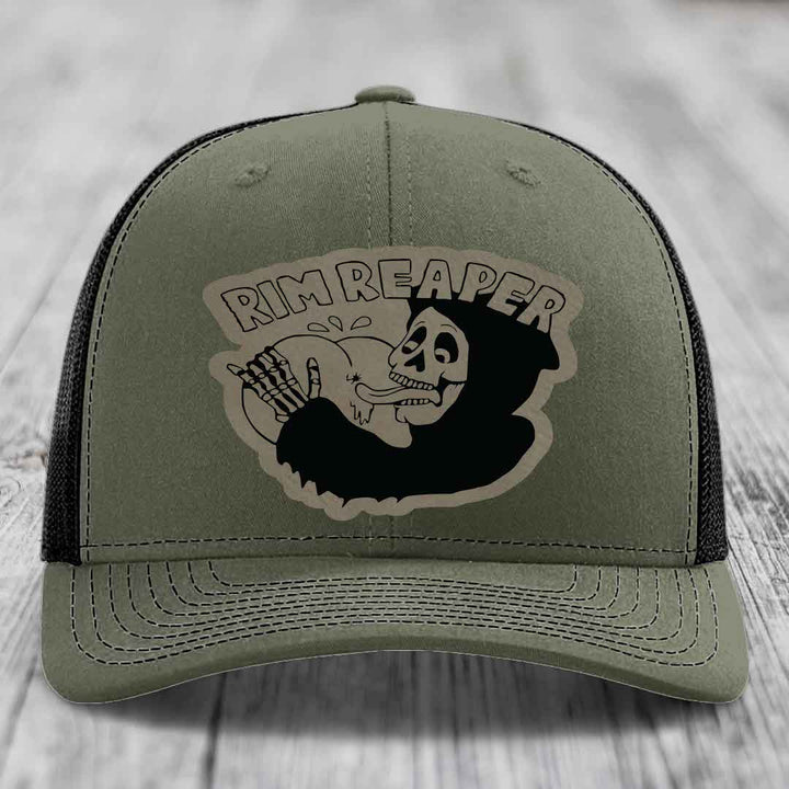 Olive green trucker hat with black mesh back and a black &