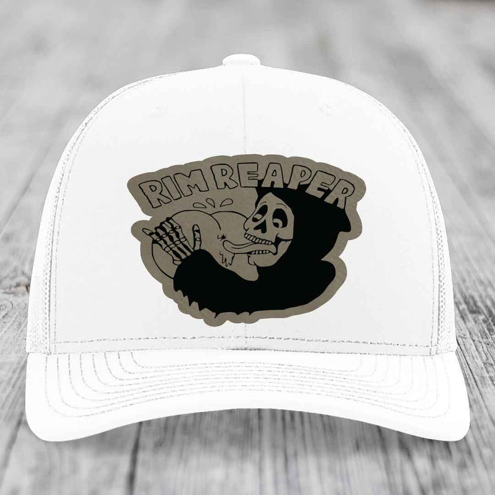 White trucker hat with a black and grey &