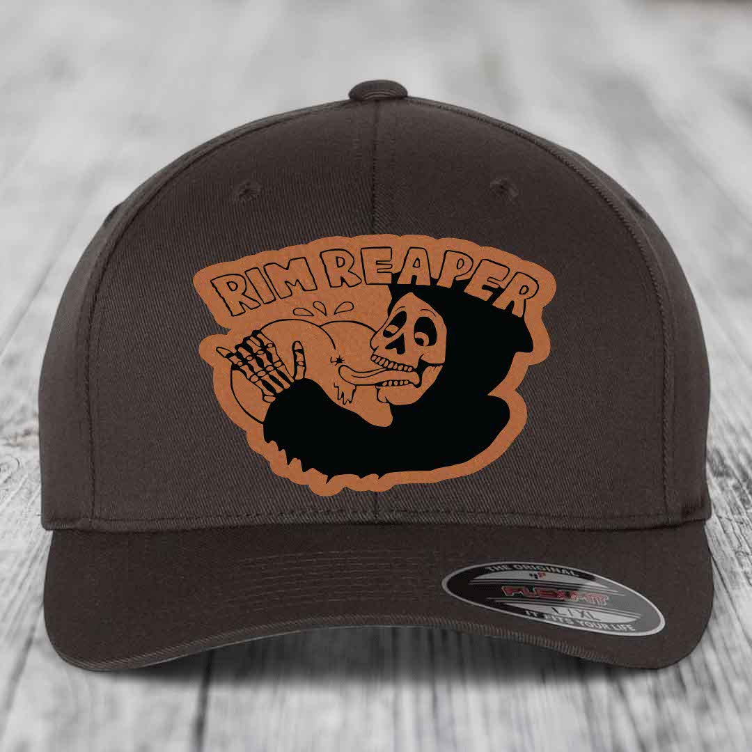 Dark brown Flexfit hat with orange Rim Reaper skull patch on front.