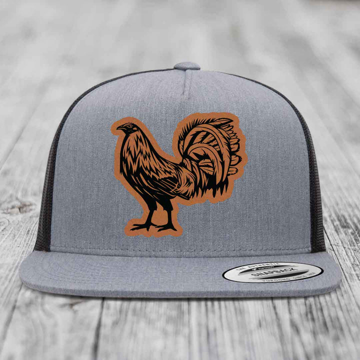 Grey trucker hat with brown leather rooster patch on front, black mesh back.