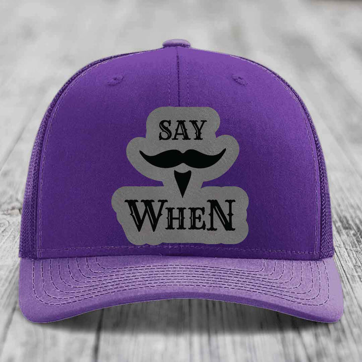 Purple trucker hat with gray patch featuring &