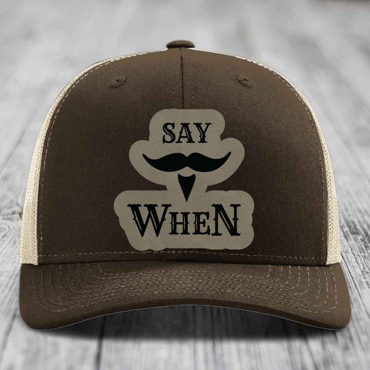 Brown trucker hat with beige mesh back and &