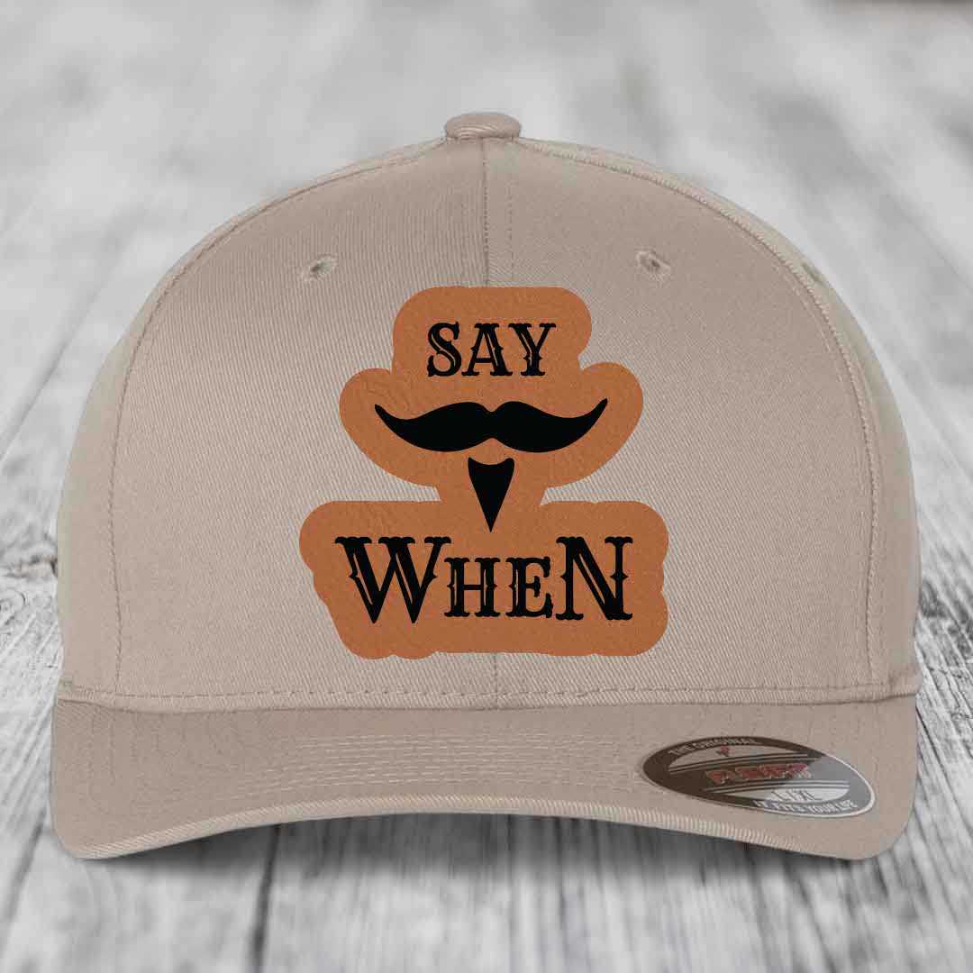 Beige baseball cap with brown leather patch reading &
