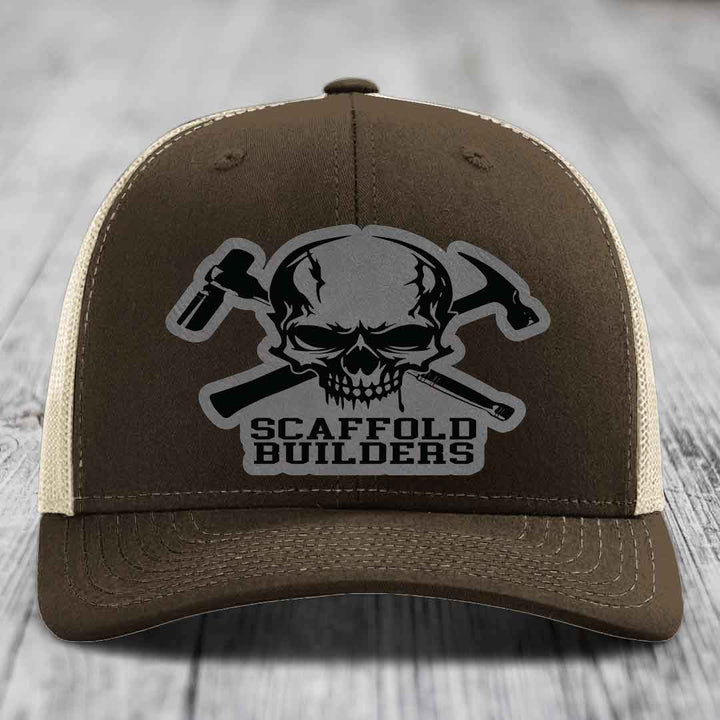 Brown trucker hat with skull and crossed hammers patch, reading &