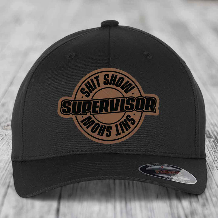 Black baseball cap with brown leather patch reading &