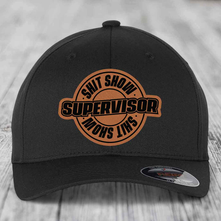 Black baseball cap with brown leather patch reading &