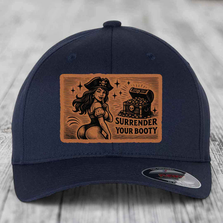 Dark blue baseball cap with brown leather patch showing pirate woman and treasure chest, text reads &