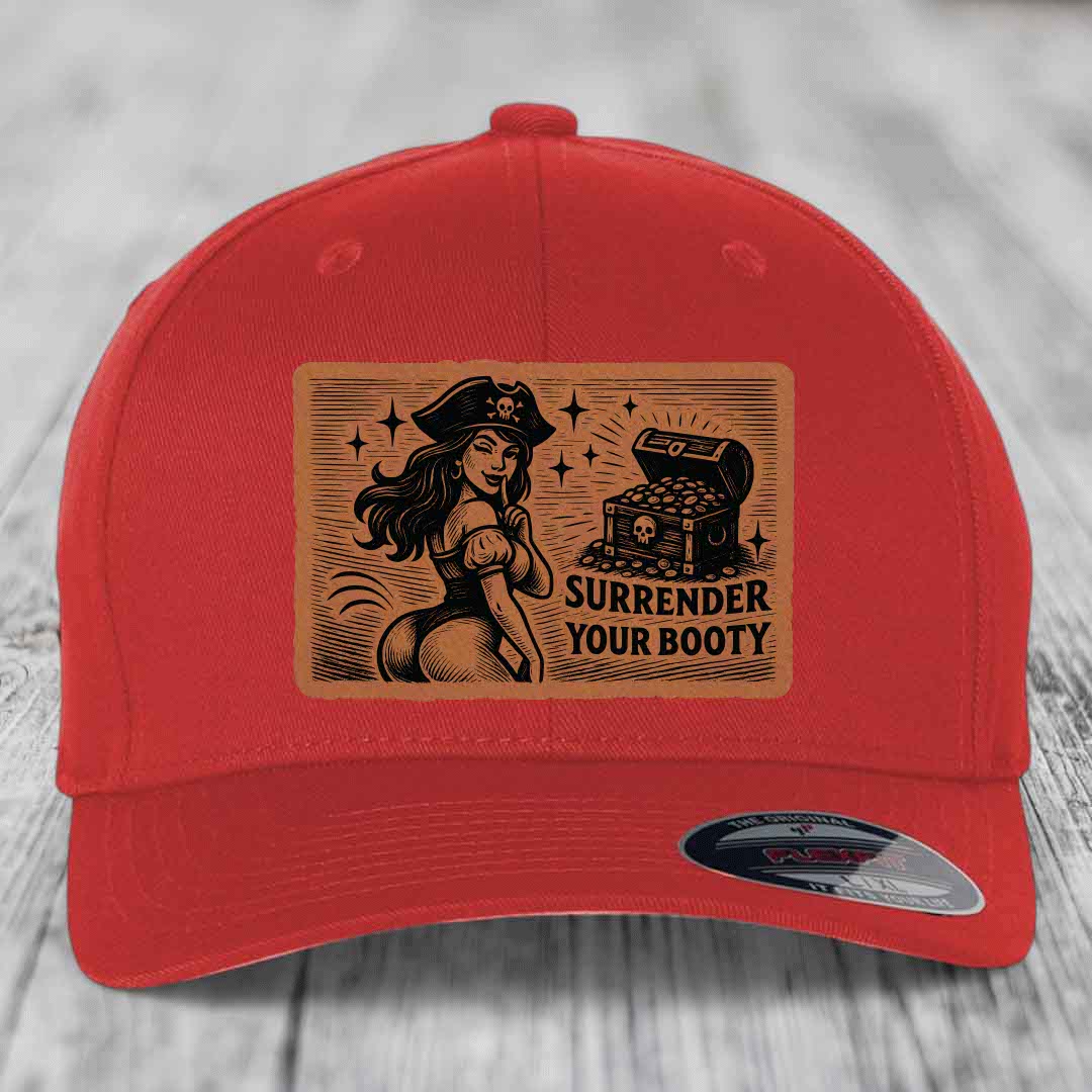 Red baseball cap with brown leatherette patch showing pirate woman and treasure chest, text reads &