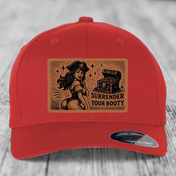 Red baseball cap with brown leatherette patch showing pirate woman and treasure chest, text reads &