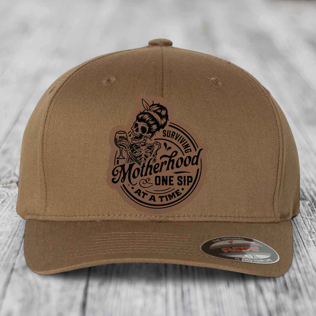 Surviving Motherhood, One Sip At A Time - Leather Patch Hat - Dark Brown to Black Patch - Flexfit 6277 Fitted Hat