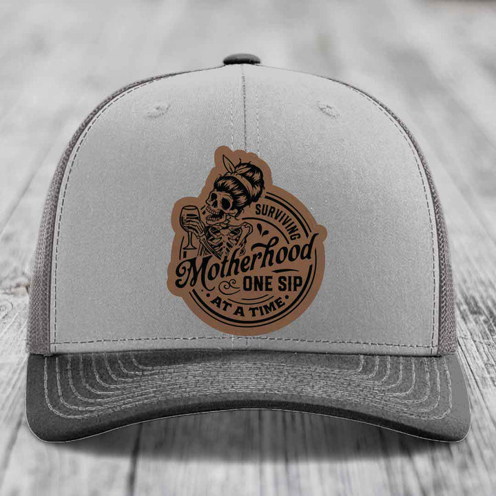 Surviving Motherhood, One Sip At A Time - Leather Patch Hat - Dark Brown to Black Patch - Richardson 112 Snapback Trucker Hat