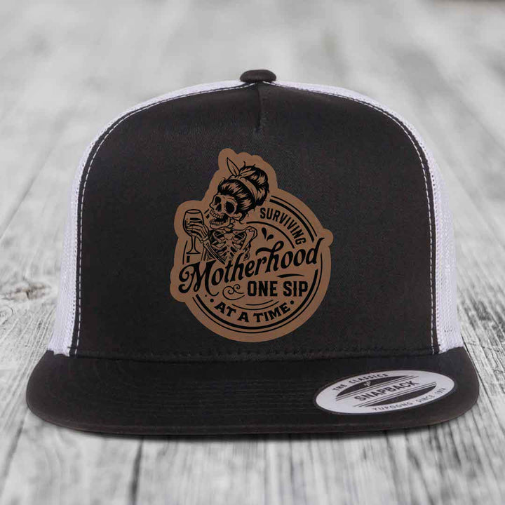 Surviving Motherhood, One Sip At A Time - Leather Patch Hat - Dark Brown to Black Patch - Yupoong 6006 Snapback Flatbill Hat