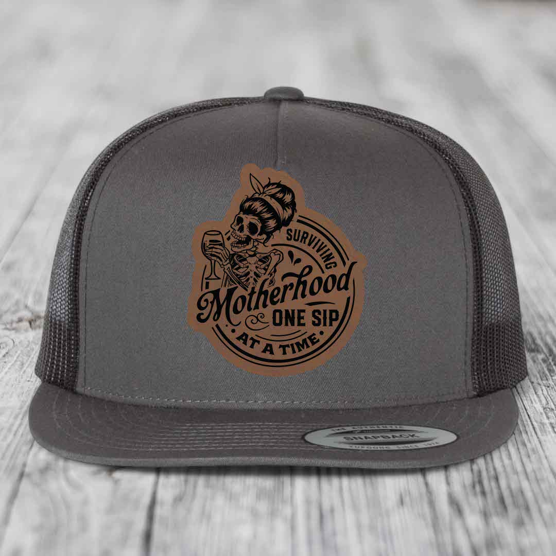 Surviving Motherhood, One Sip At A Time - Leather Patch Hat - Dark Brown to Black Patch - Yupoong 6006 Snapback Flatbill Hat