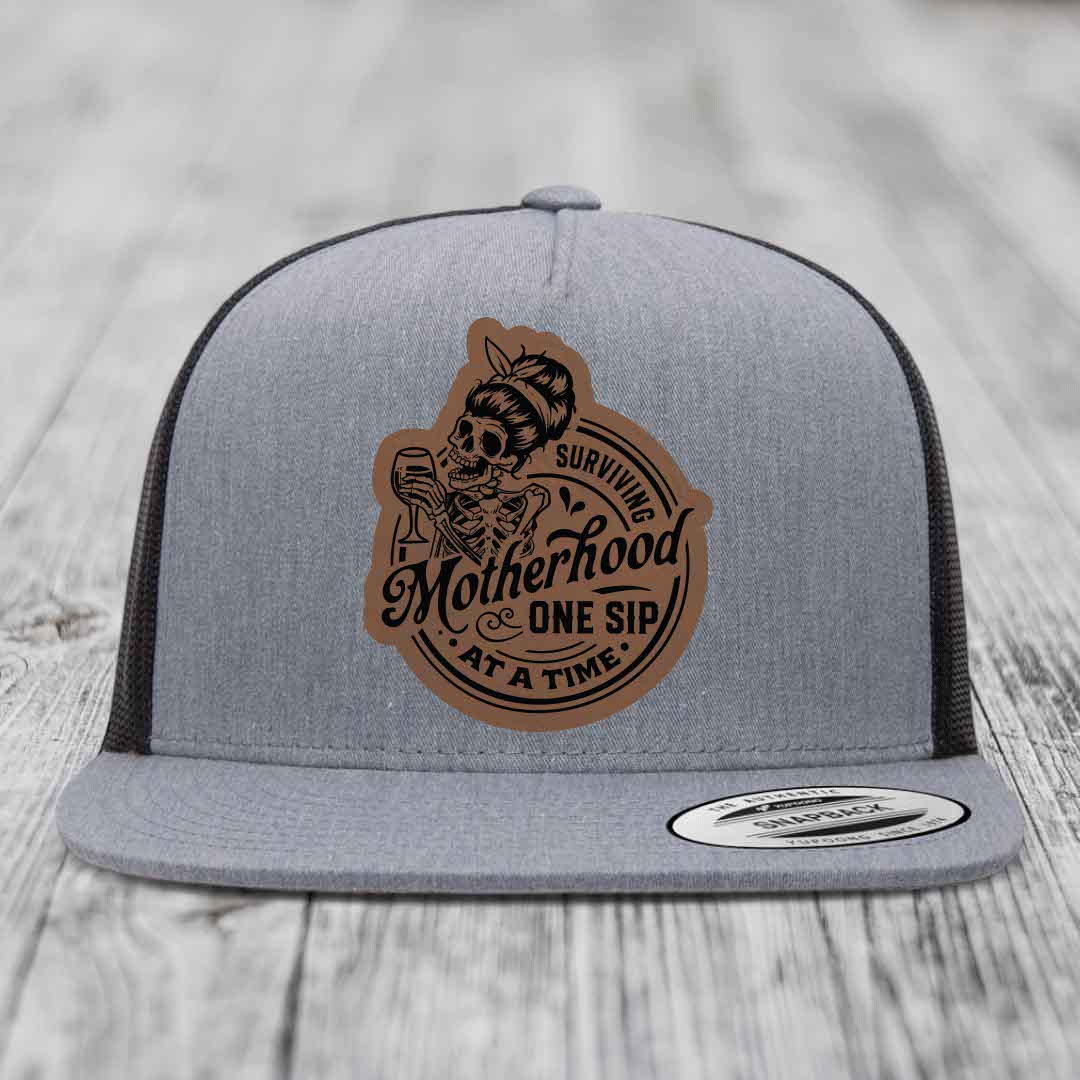 Surviving Motherhood, One Sip At A Time - Leather Patch Hat - Dark Brown to Black Patch - Yupoong 6006 Snapback Flatbill Hat