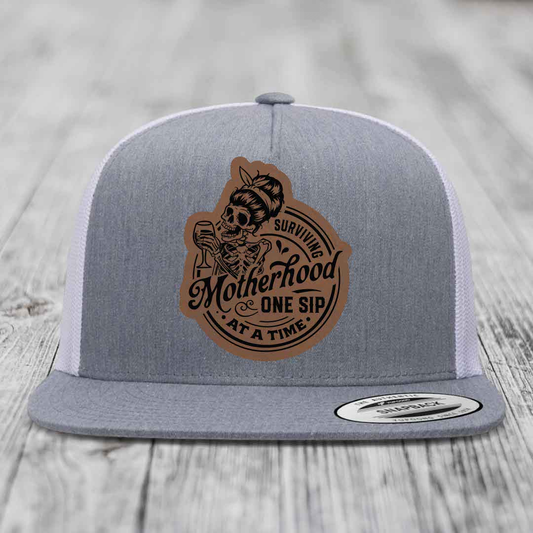 Surviving Motherhood, One Sip At A Time - Leather Patch Hat - Dark Brown to Black Patch - Yupoong 6006 Snapback Flatbill Hat