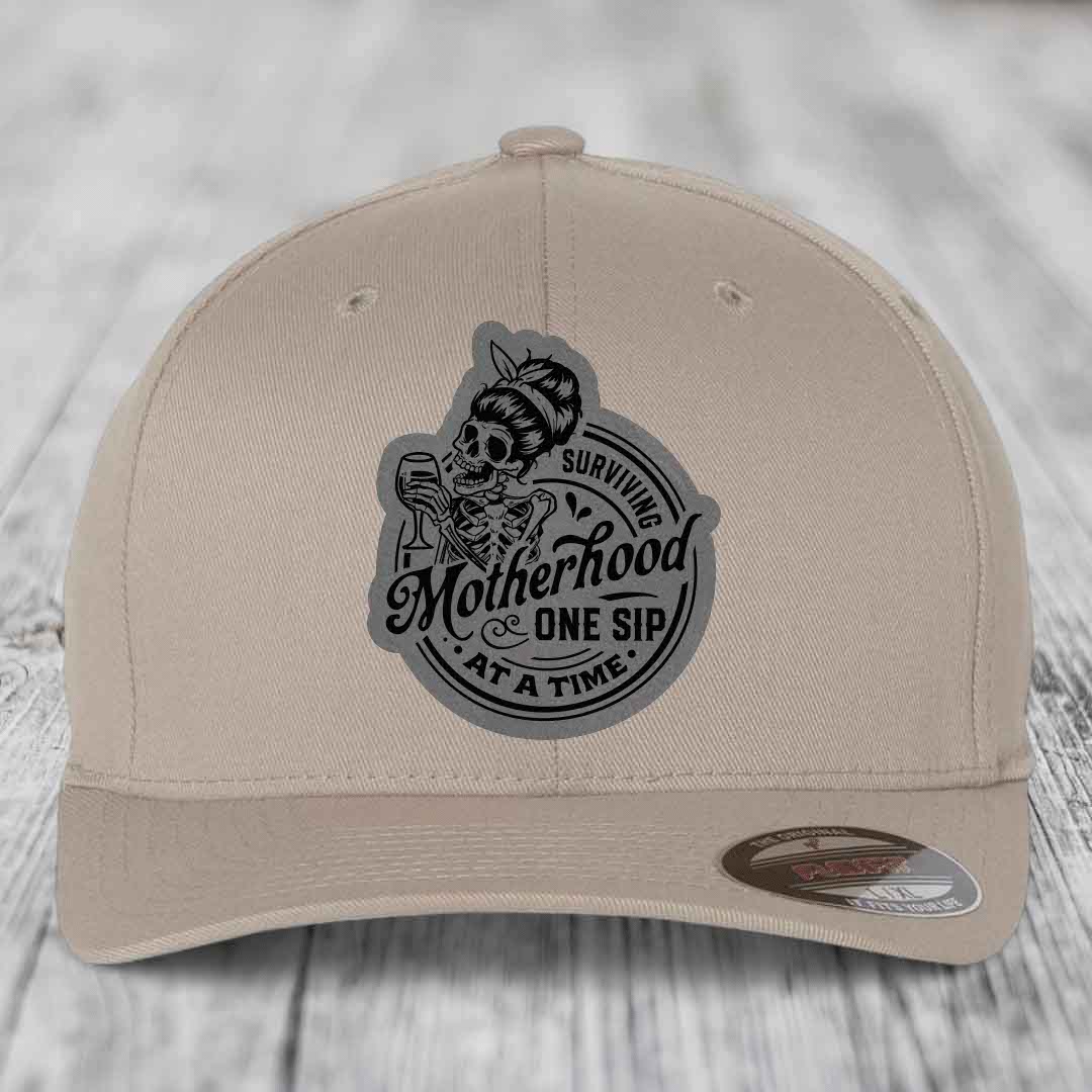Surviving Motherhood, One Sip At A Time - Leather Patch Hat - Grey to Black Patch - Flexfit 6277 Fitted Hat