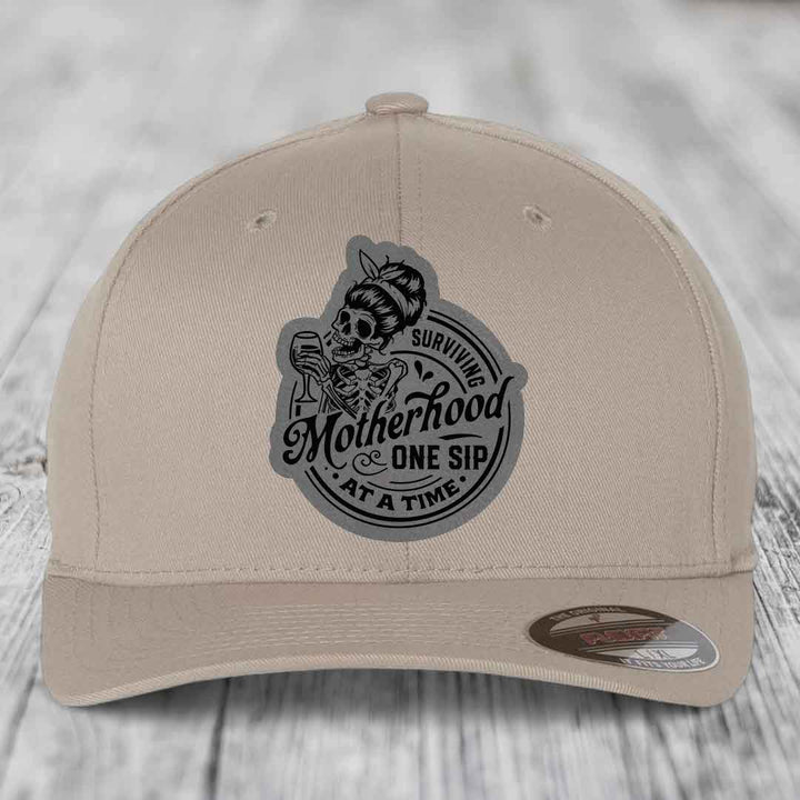 Surviving Motherhood, One Sip At A Time - Leather Patch Hat - Grey to Black Patch - Flexfit 6277 Fitted Hat