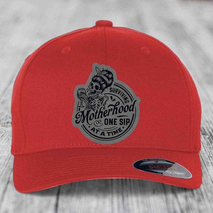 Surviving Motherhood, One Sip At A Time - Leather Patch Hat - Grey to Black Patch - Flexfit 6277 Fitted Hat