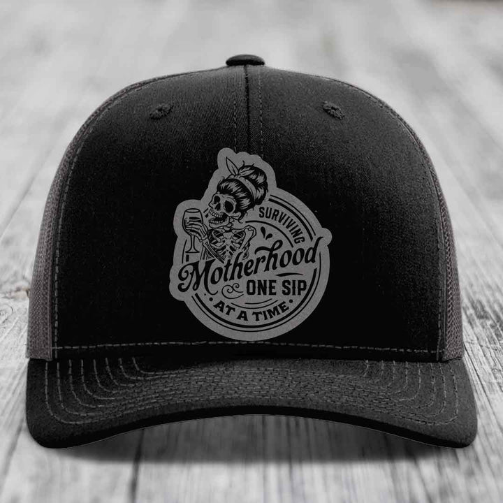 Surviving Motherhood, One Sip At A Time - Leather Patch Hat - Grey to Black Patch - Richardson 112 Snapback Trucker Hat
