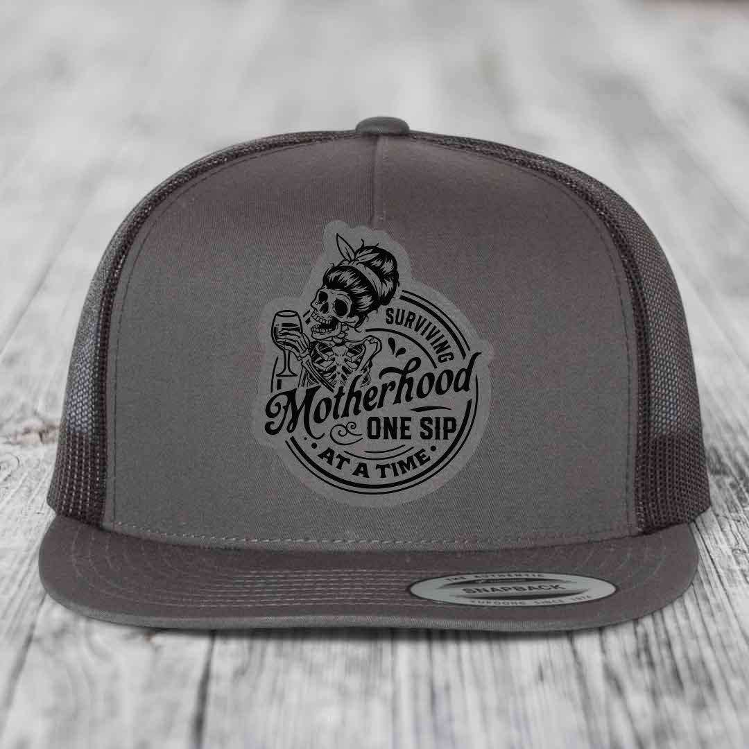 Surviving Motherhood, One Sip At A Time - Leather Patch Hat - Grey to Black Patch - Yupoong 6006 Snapback Flatbill Hat