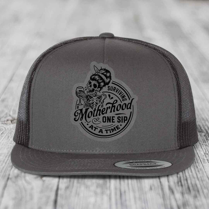 Surviving Motherhood, One Sip At A Time - Leather Patch Hat - Grey to Black Patch - Yupoong 6006 Snapback Flatbill Hat