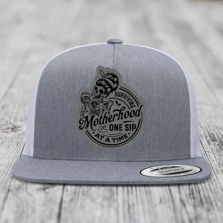 Surviving Motherhood, One Sip At A Time - Leather Patch Hat - Grey to Black Patch - Yupoong 6006 Snapback Flatbill Hat