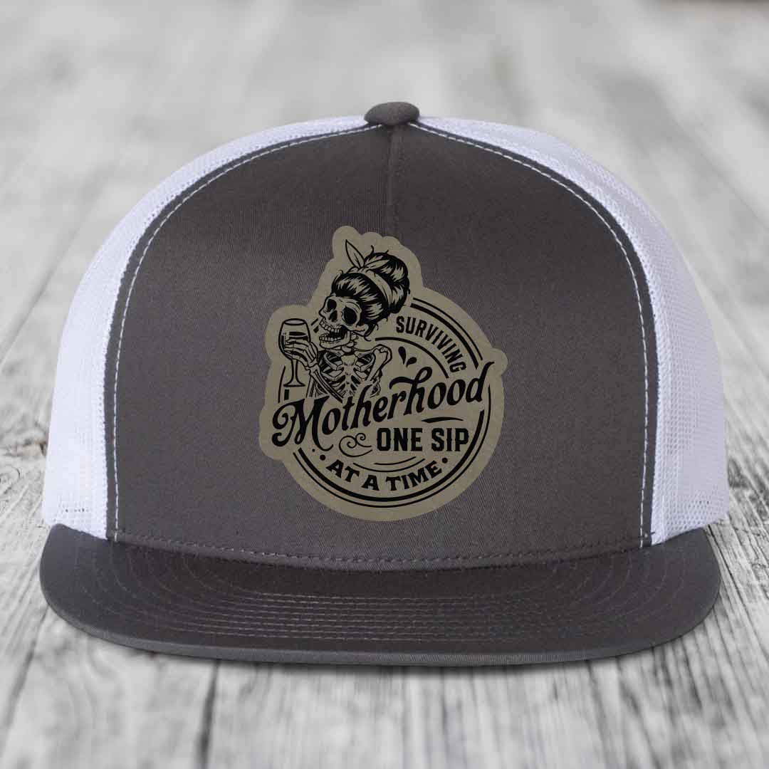 Surviving Motherhood, One Sip At A Time - Leather Patch Hat - Light Brown to Black Patch - Yupoong 6006 Snapback Flatbill Hat