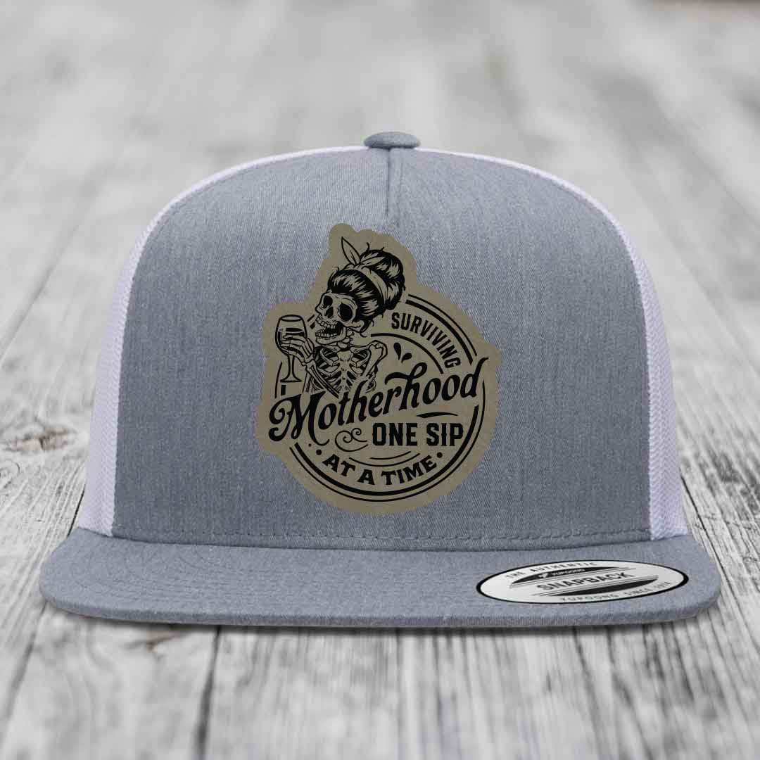 Surviving Motherhood, One Sip At A Time - Leather Patch Hat - Light Brown to Black Patch - Yupoong 6006 Snapback Flatbill Hat