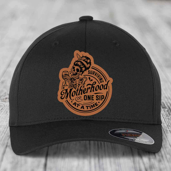Surviving Motherhood, One Sip At A Time - Leather Patch Hat - Rawhide to Black Patch - Flexfit 6277 Fitted Hat