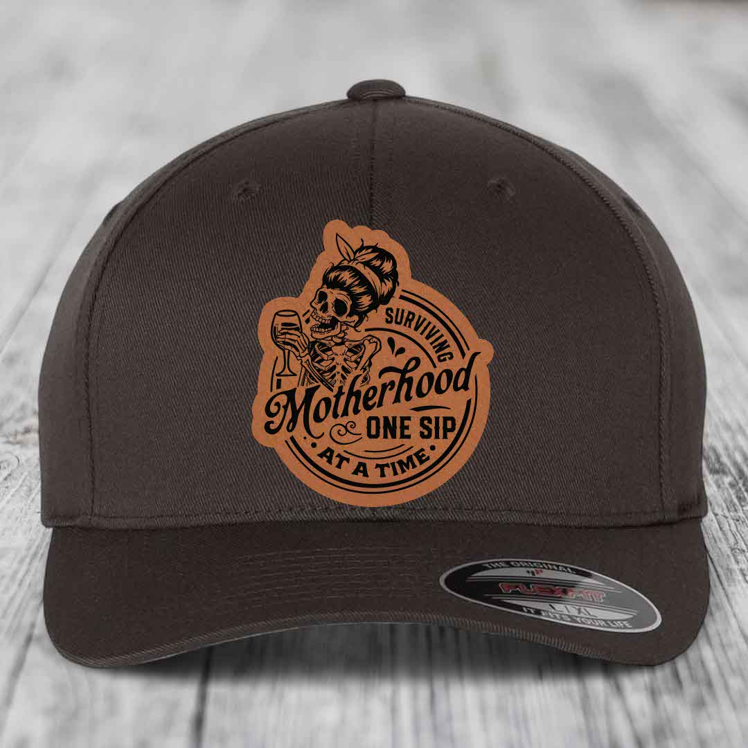 Surviving Motherhood, One Sip At A Time - Leather Patch Hat - Rawhide to Black Patch - Flexfit 6277 Fitted Hat