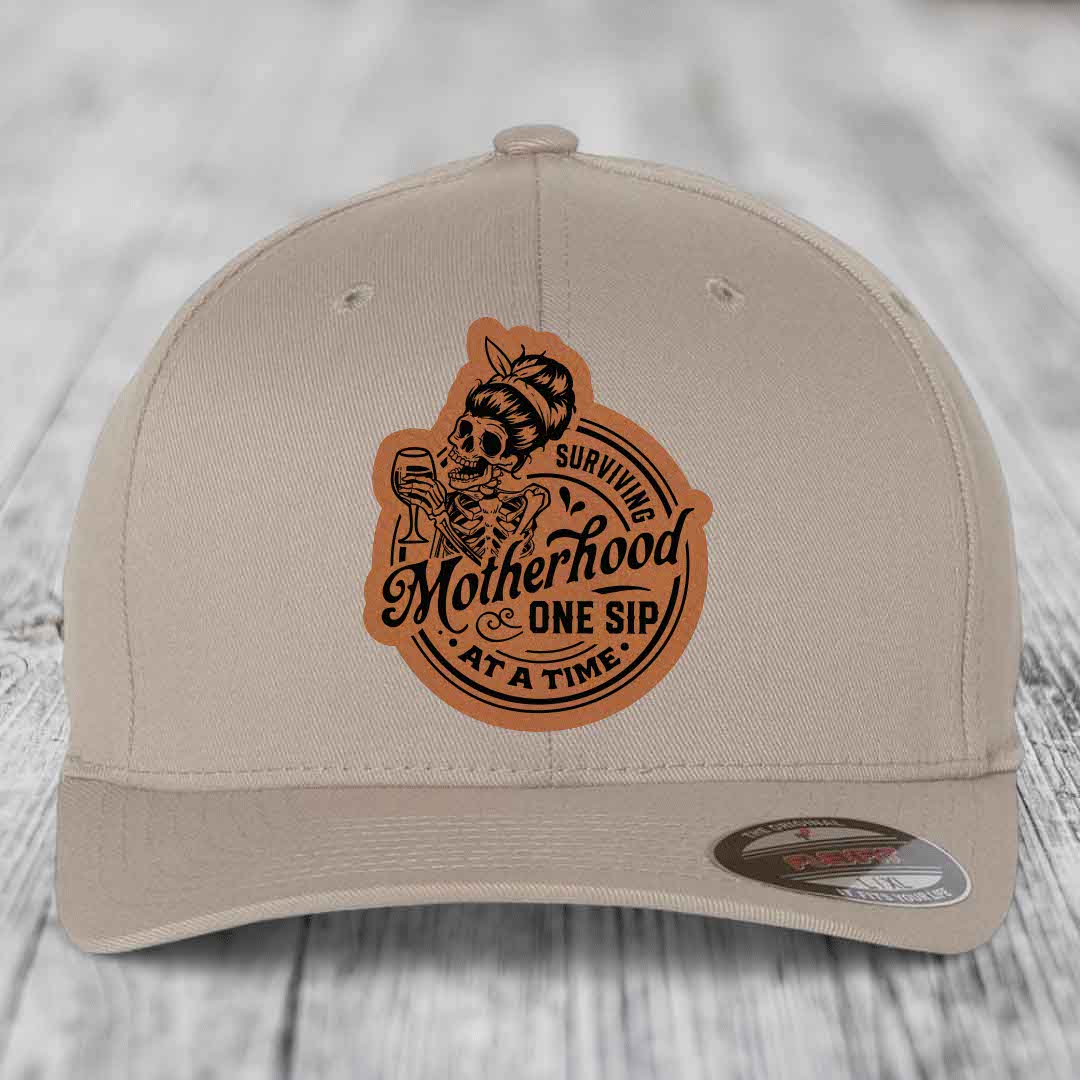 Surviving Motherhood, One Sip At A Time - Leather Patch Hat - Rawhide to Black Patch - Flexfit 6277 Fitted Hat