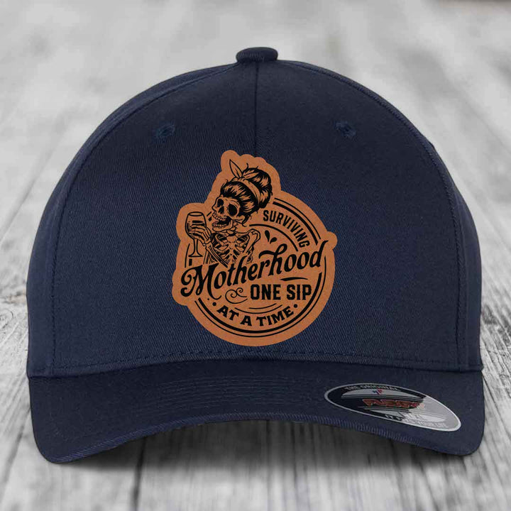 Surviving Motherhood, One Sip At A Time - Leather Patch Hat - Rawhide to Black Patch - Flexfit 6277 Fitted Hat