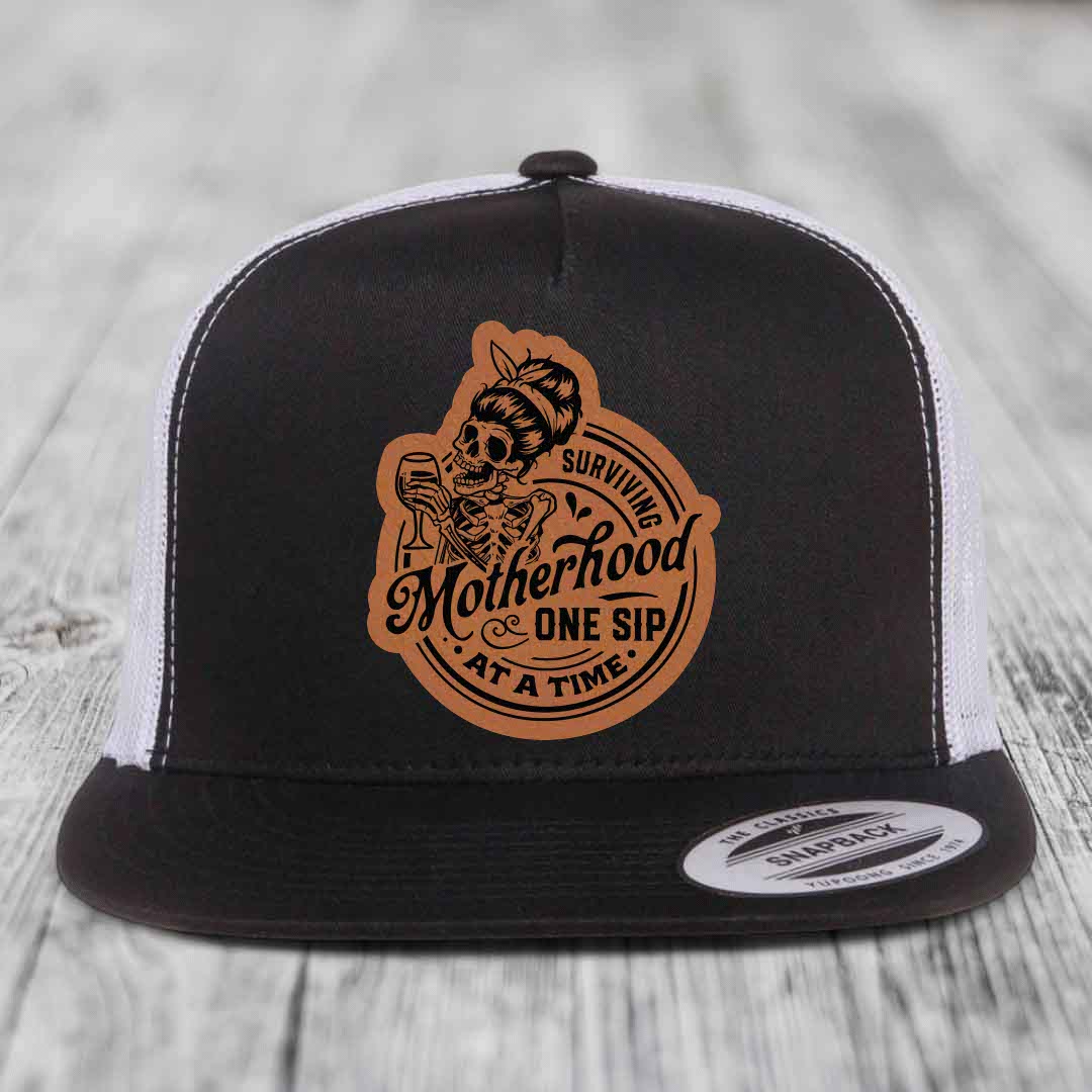 Surviving Motherhood, One Sip At A Time - Leather Patch Hat - Rawhide to Black Patch - Yupoong 6006 Snapback Flatbill Hat