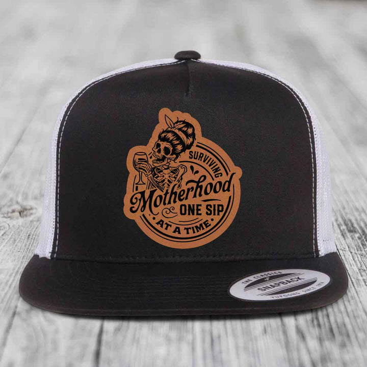 Surviving Motherhood, One Sip At A Time - Leather Patch Hat - Rawhide to Black Patch - Yupoong 6006 Snapback Flatbill Hat