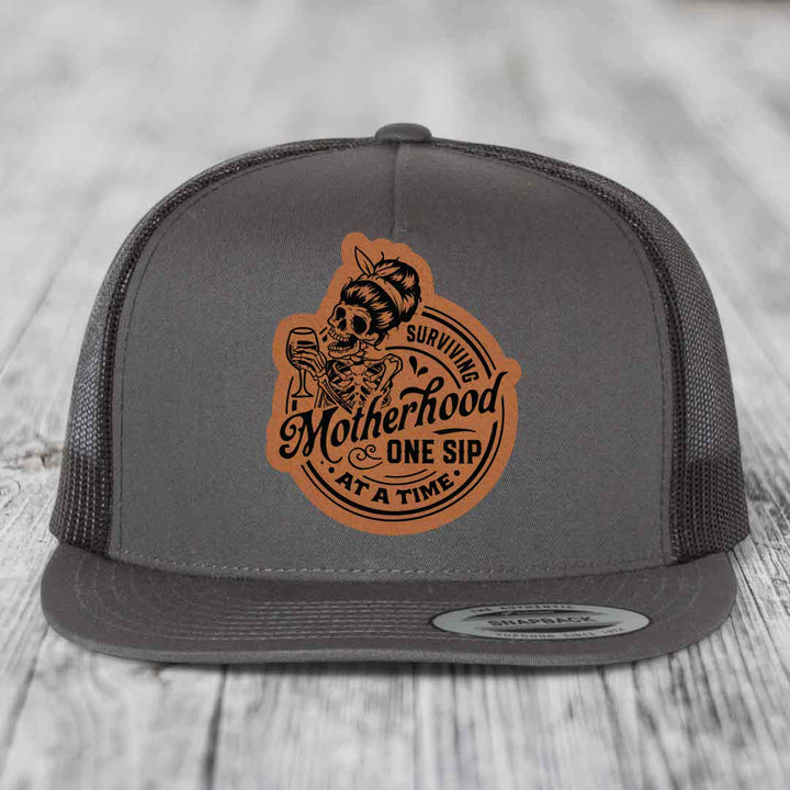 Surviving Motherhood, One Sip At A Time - Leather Patch Hat - Rawhide to Black Patch - Yupoong 6006 Snapback Flatbill Hat