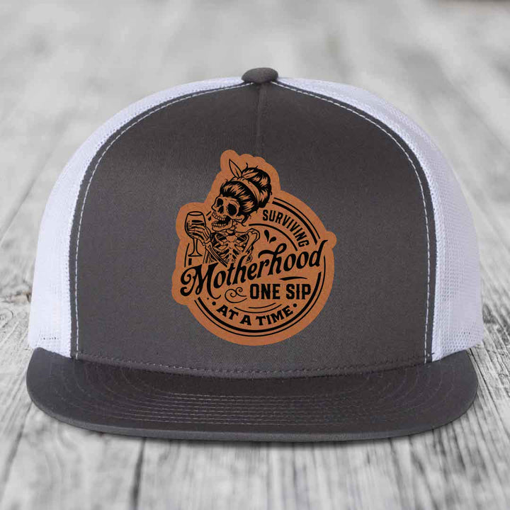 Surviving Motherhood, One Sip At A Time - Leather Patch Hat - Rawhide to Black Patch - Yupoong 6006 Snapback Flatbill Hat