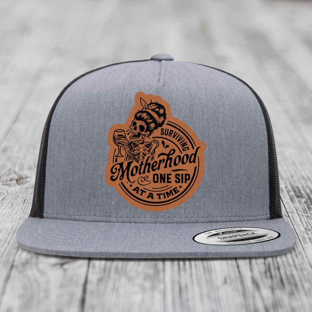 Surviving Motherhood, One Sip At A Time - Leather Patch Hat - Rawhide to Black Patch - Yupoong 6006 Snapback Flatbill Hat