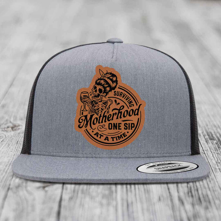 Surviving Motherhood, One Sip At A Time - Leather Patch Hat - Rawhide to Black Patch - Yupoong 6006 Snapback Flatbill Hat