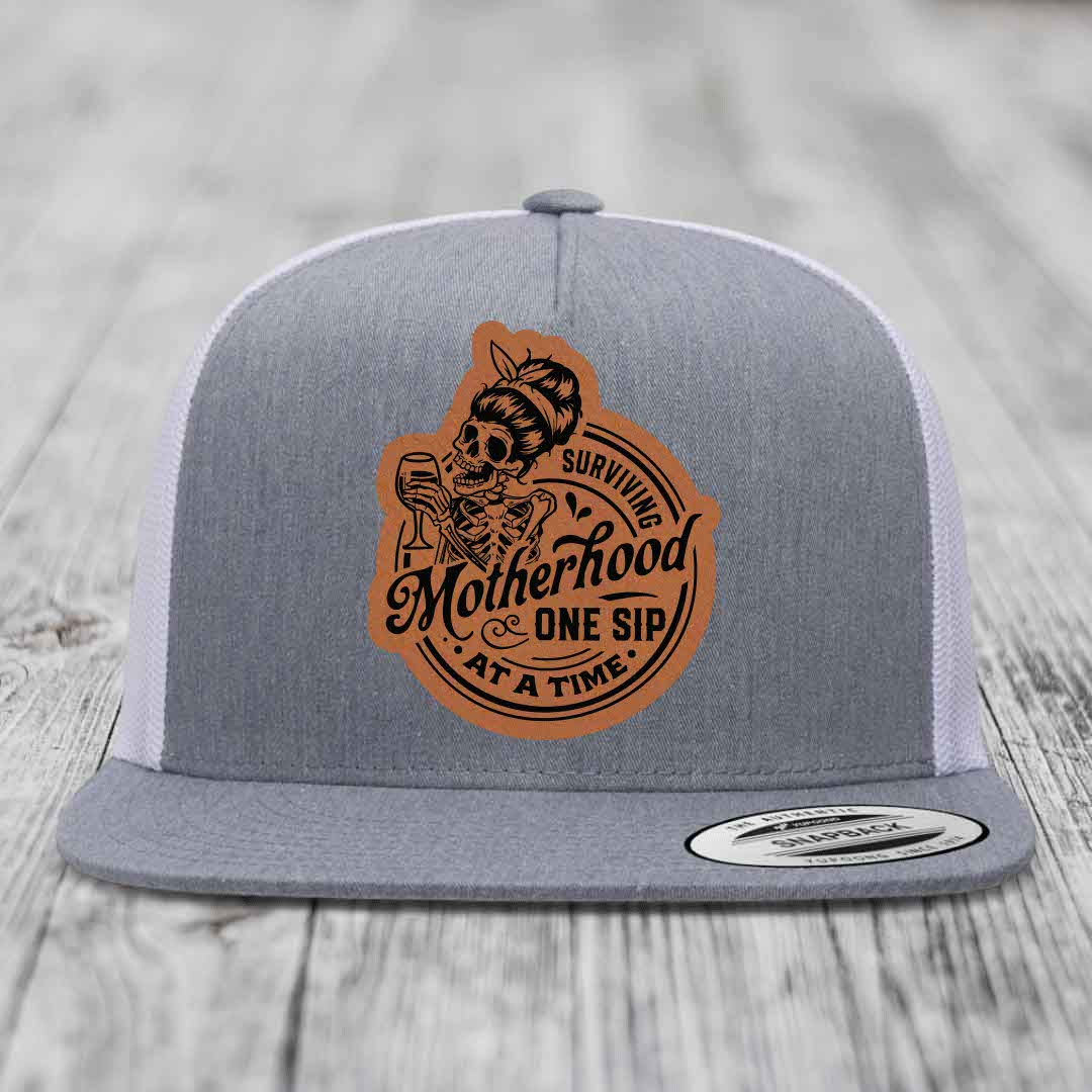 Surviving Motherhood, One Sip At A Time - Leather Patch Hat - Rawhide to Black Patch - Yupoong 6006 Snapback Flatbill Hat