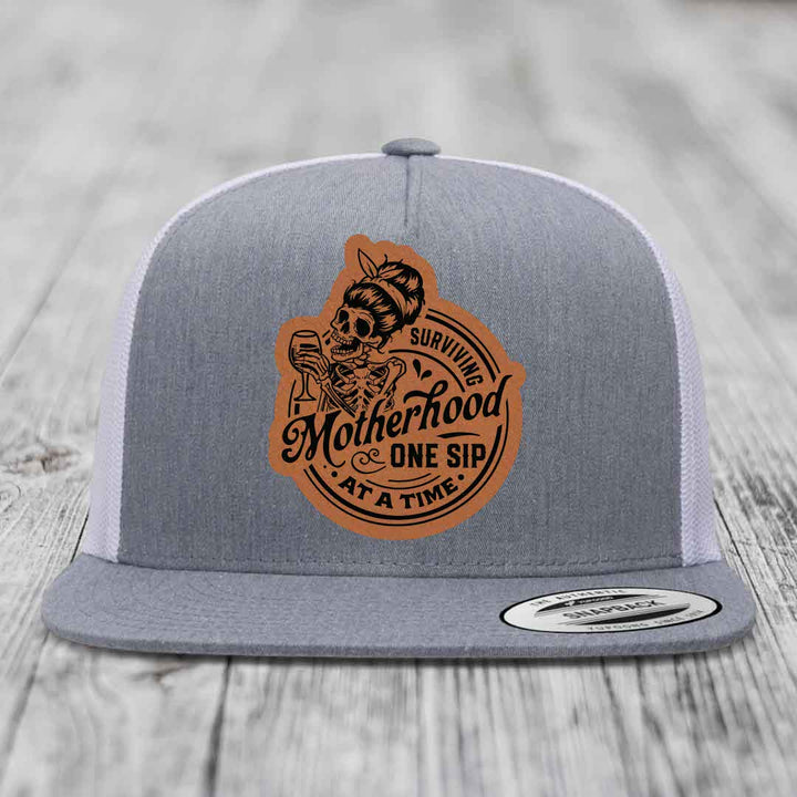 Surviving Motherhood, One Sip At A Time - Leather Patch Hat - Rawhide to Black Patch - Yupoong 6006 Snapback Flatbill Hat