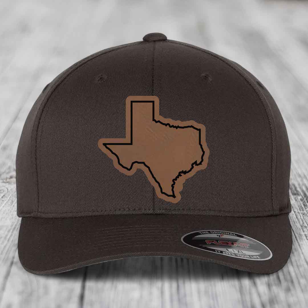 Dark brown Flexfit hat with a tan Texas state outline patch on front.